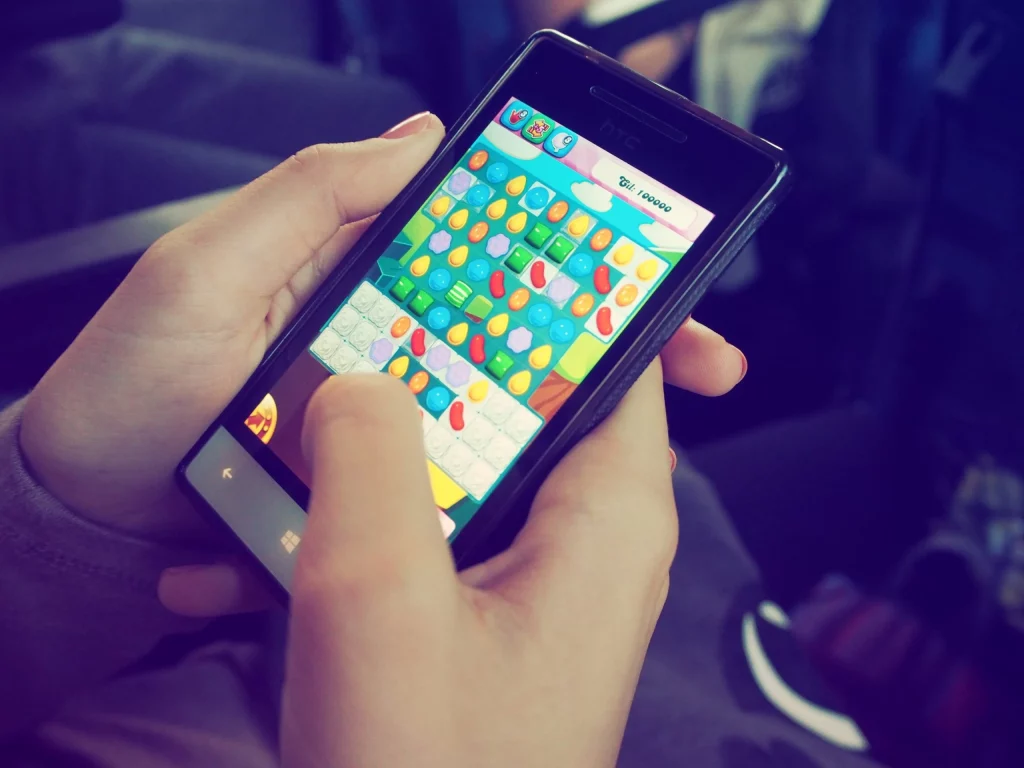 Picture of a person playing a mobile game