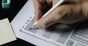 Image of a person filling a multiple choice language exam