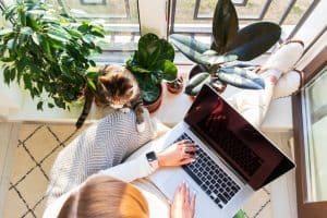 Remote learning - person, laptop, flower and a cat