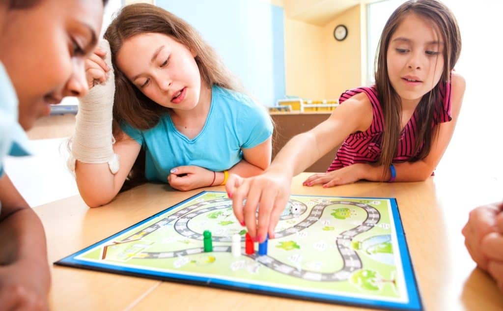 Students playing a board game during a language class