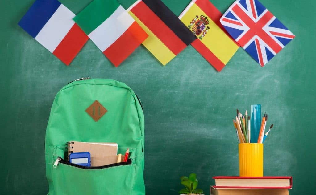Image of a backbag, country flags and other school equipment